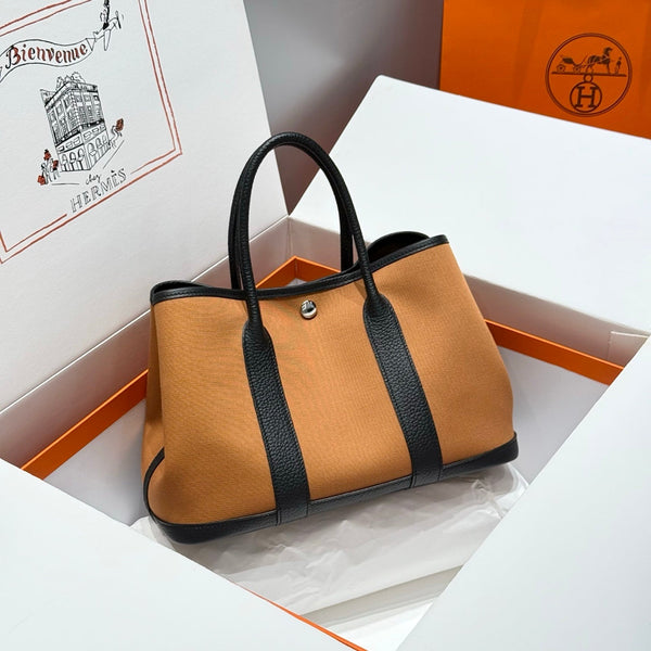 GARDEN PARTY 30CM IN ORANGE MINIMUM TOILETTEN BAUMWOLL-CANVAS UND SCHWARZES KALBSLEDER